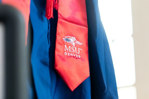 A picture of a cap and gown, zoomed in on the red regalia