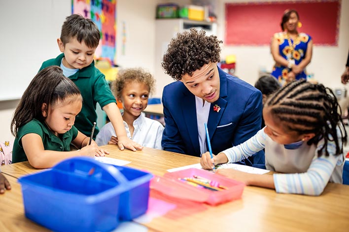 MSU Denver’s Jordan Puch talks with students in a classroom at Green Valley Elementary School on Sept. 25, 2023.