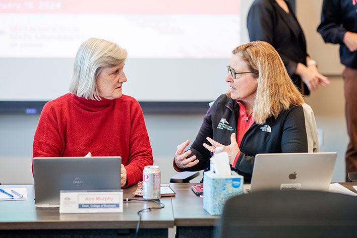 Dean Ann Murphy talks with Liz Hinde, dean of the School of Education, at an MSU Denver Board of Trustees meeting in January.