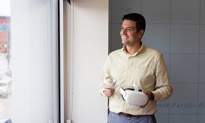 School of Hospitality professor Kiyan Shafieizadeh try out the Oculus virtual reality goggles in the Hospitality Learning Center on the Auraria Campus.