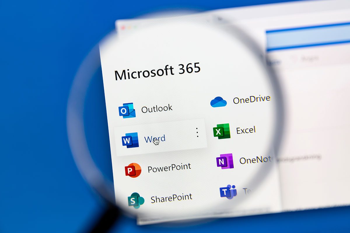 Illustration of magnifying glass hovering over Microsoft Office 365 logos on a screen.