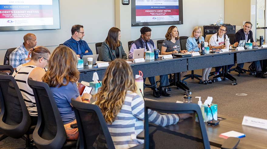 President Janine Davidson and members of her cabinet sit around a table during a meeting on September 26, 2024.