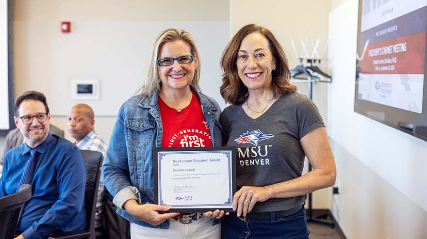 Nicolette Giasolli, Biology lecturer,   receives a Shoutout Award from President Janine Davidson.