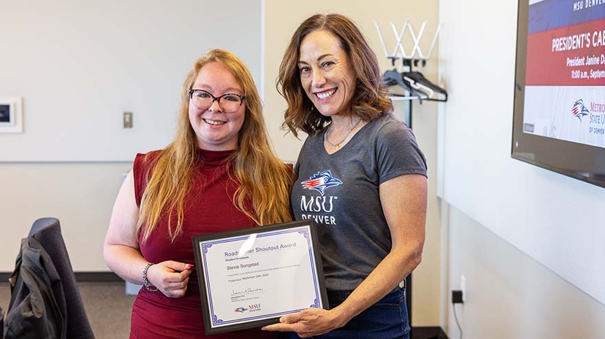 Stevie Songstand, student employee, receives a Shoutout Award from President Janine Davidson.