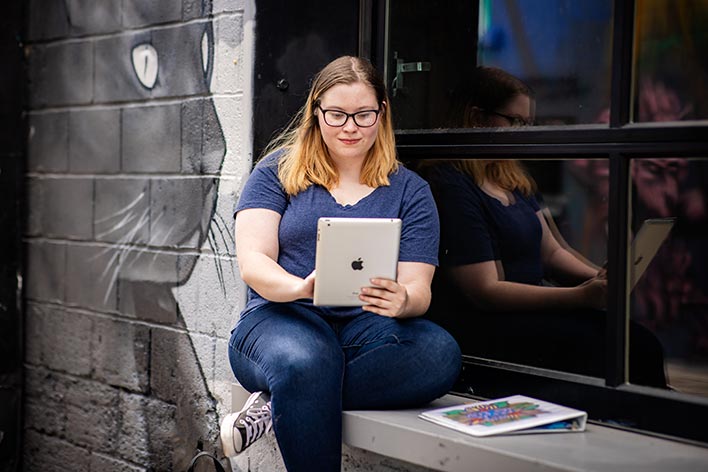 MSU Denver student Alyson Doty works on a tablet in downtown Denver.