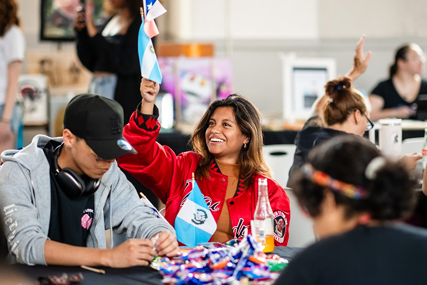 Student cheers during an HSI Week celebration.