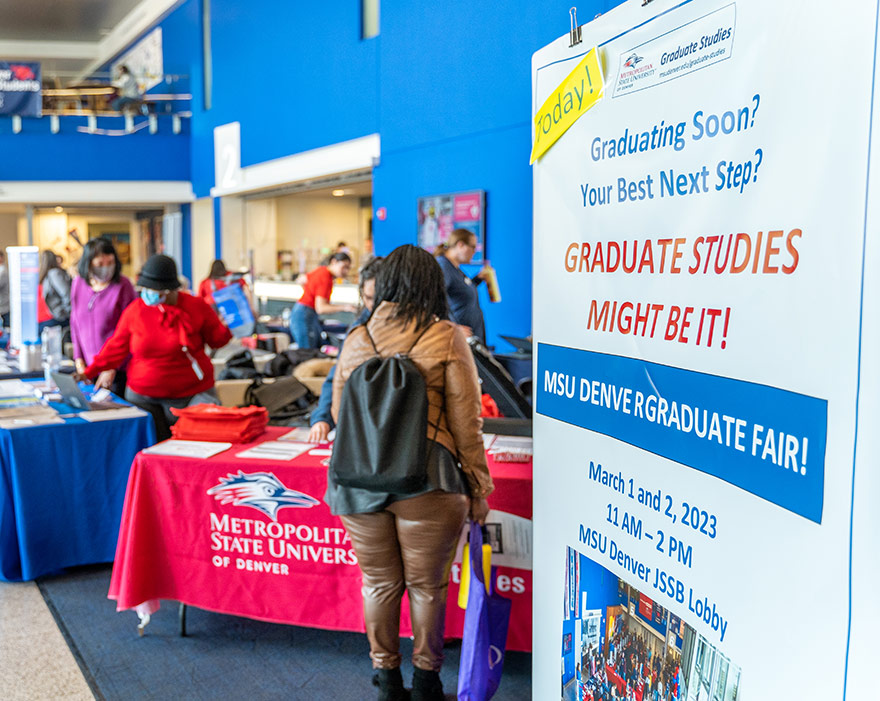 Sign welcoming prospective students to an MSU Denver Graduate Studies informational fair.