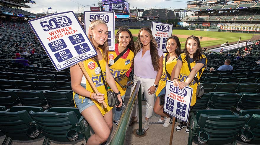 Portrait of 50/50 Raffle sellers at Coors Field Rockies game