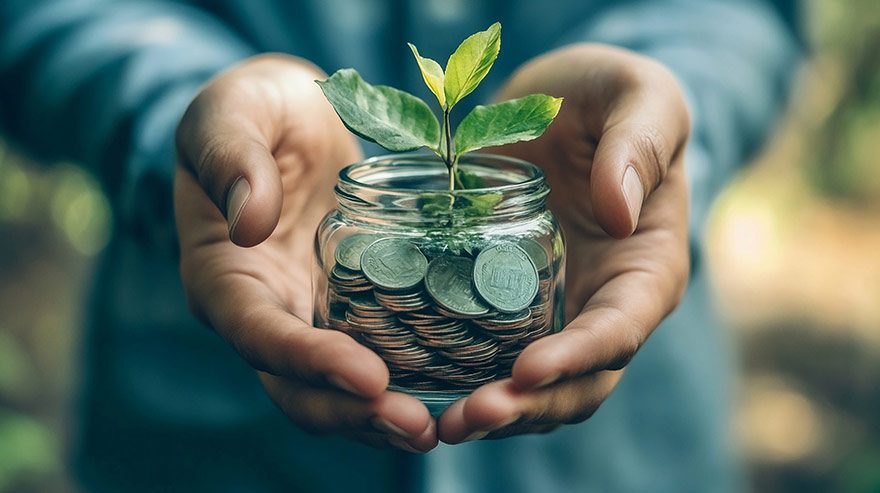 Man holding jar of coins with a plant growing from it, symbolizing financial growth.