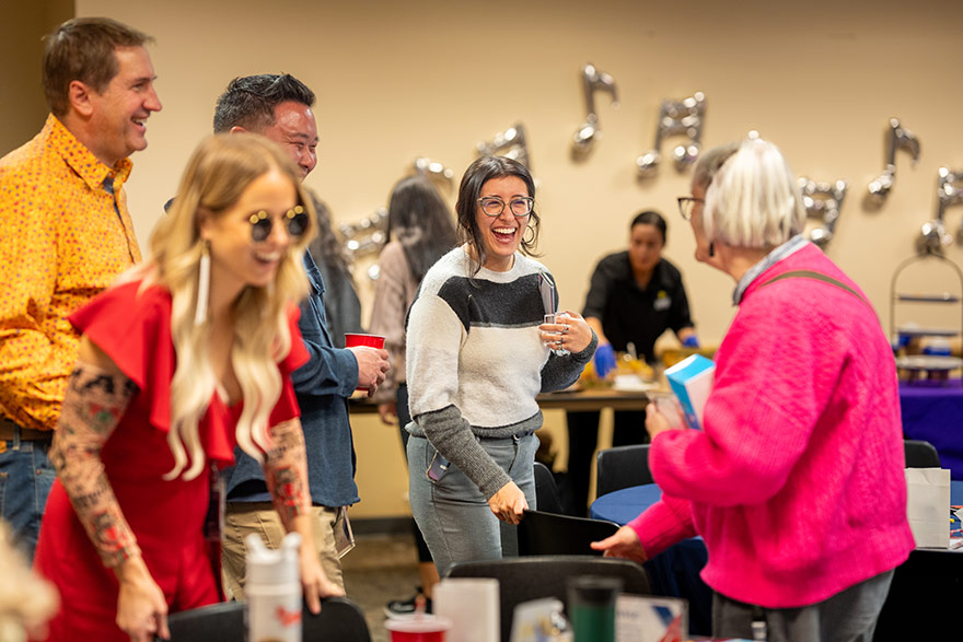 Employees celebrating awards with laughter and smiles.