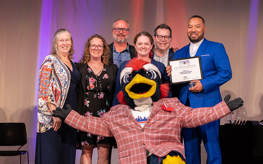 Award winners pose for a group shot in front of the Rowdy mascot