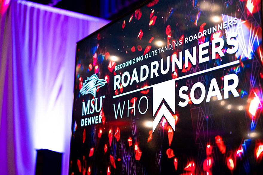 Photo of Roadrunners Who Soar banner at the entrance of a banquet hall.