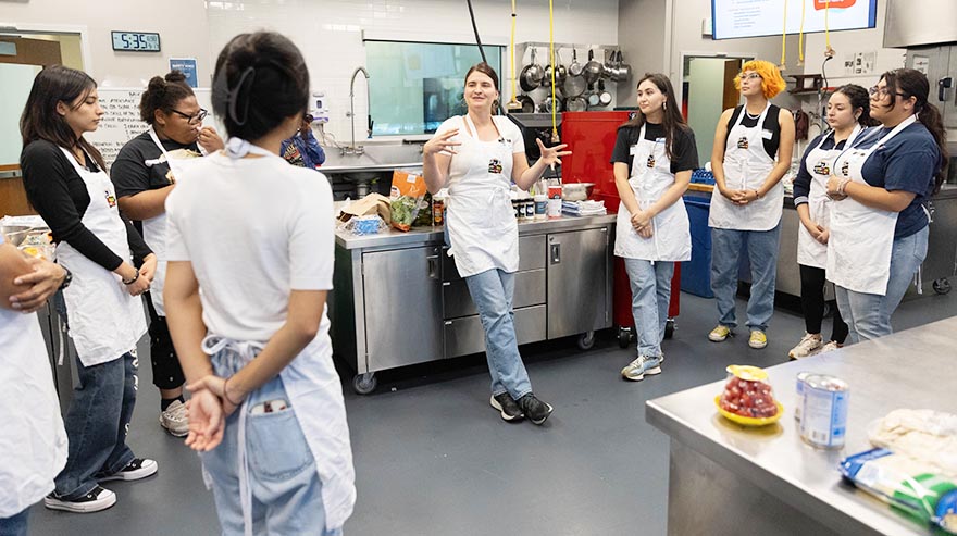 Natalie Nowak, MS, RD, center, leads a cooking class at the School of Hospitality.