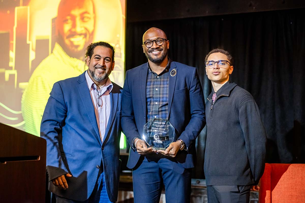 MLK Peace Awardee Jermaine Gunnells, center, with Michael Benitez, Ph.D., left and student Cy Holt.