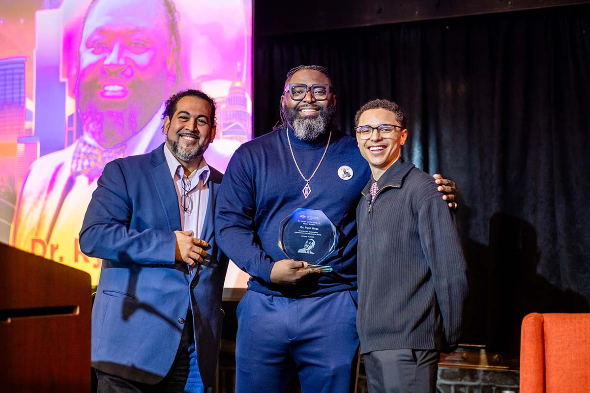 MLK Peace Awardee Ryan Ross, Ph.D., center, with Michael Benitez, Ph.D., left, and student Cy Holt.