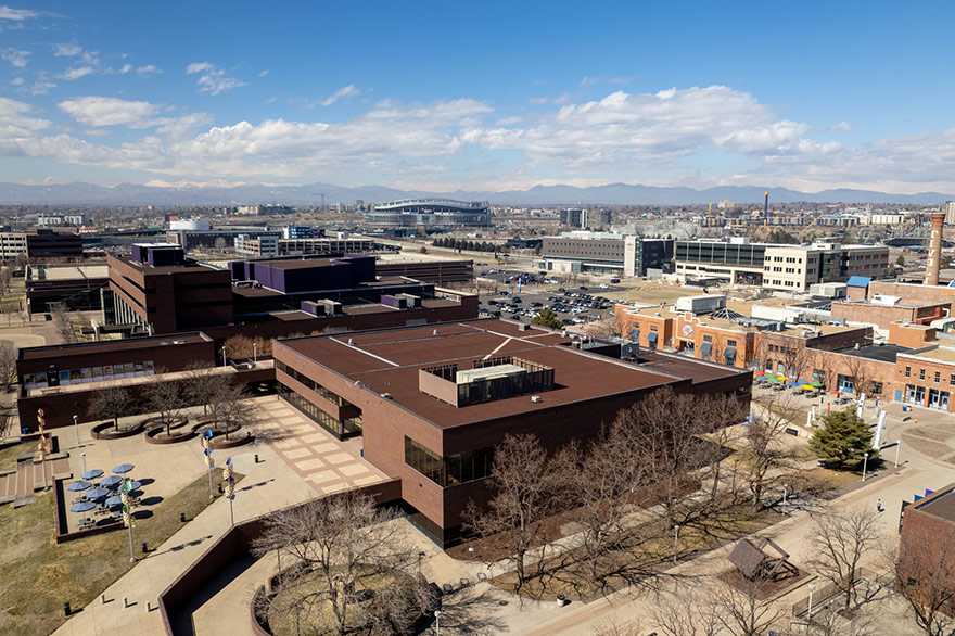 Aerial view of the Plaza Building on the Auraria Campus with mountains in the background