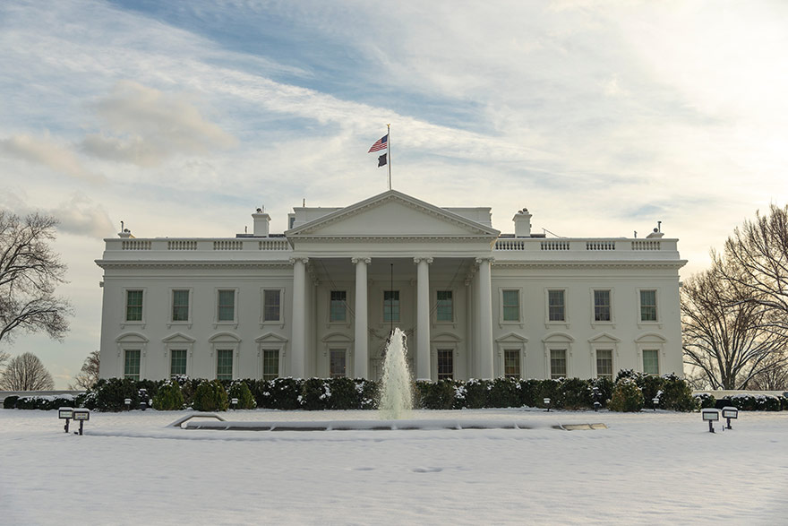 Image of the White House with snow on the lawn.