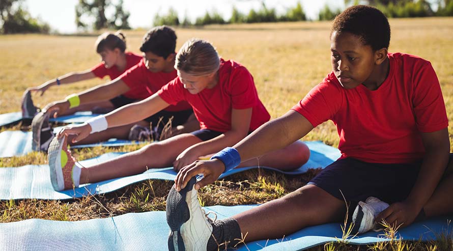 Kids stretching in field