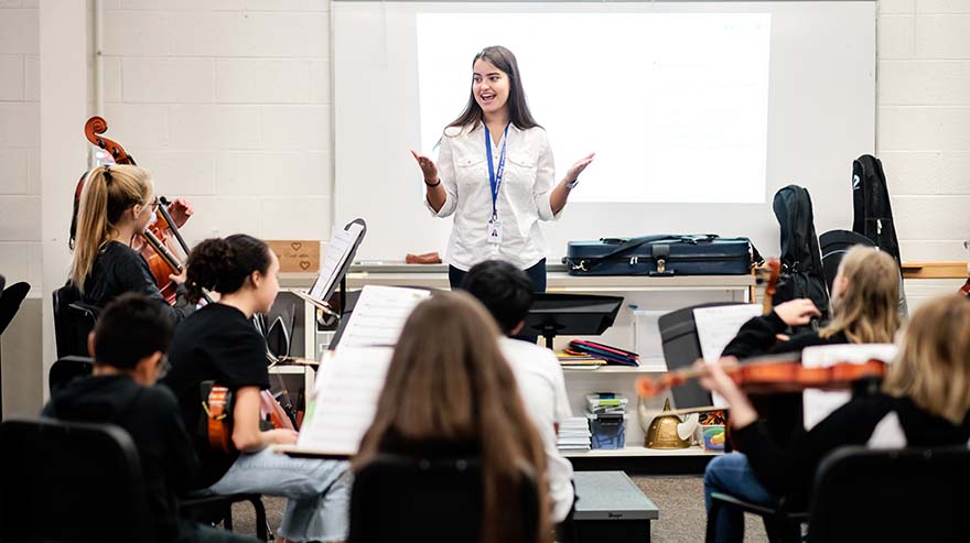 MSU Denver student Hannah Baty conducts rehearsal with the 7th grade orchestra at Euclid Middle School as part of her student teaching experience.