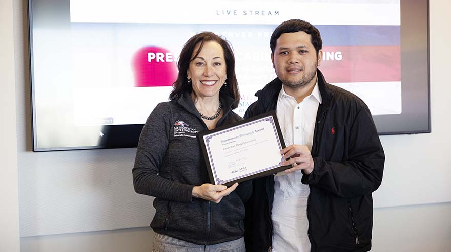 President Janine Davidson, Ph.D., with Roadrunner Shoutout Award student winner Kevin San Diego Manaysay.