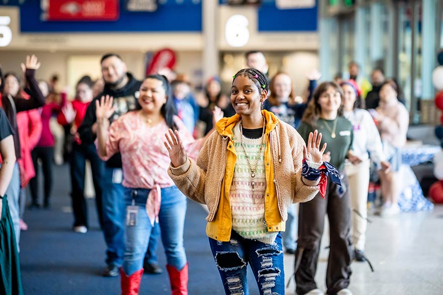 Employees participate in line dancing.