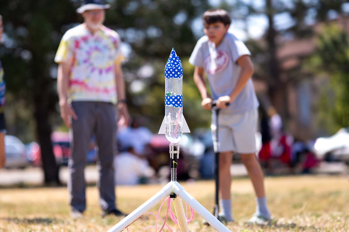 Summer Science Institute student Oberklain Jauregui pressurizes his rocket before launching.