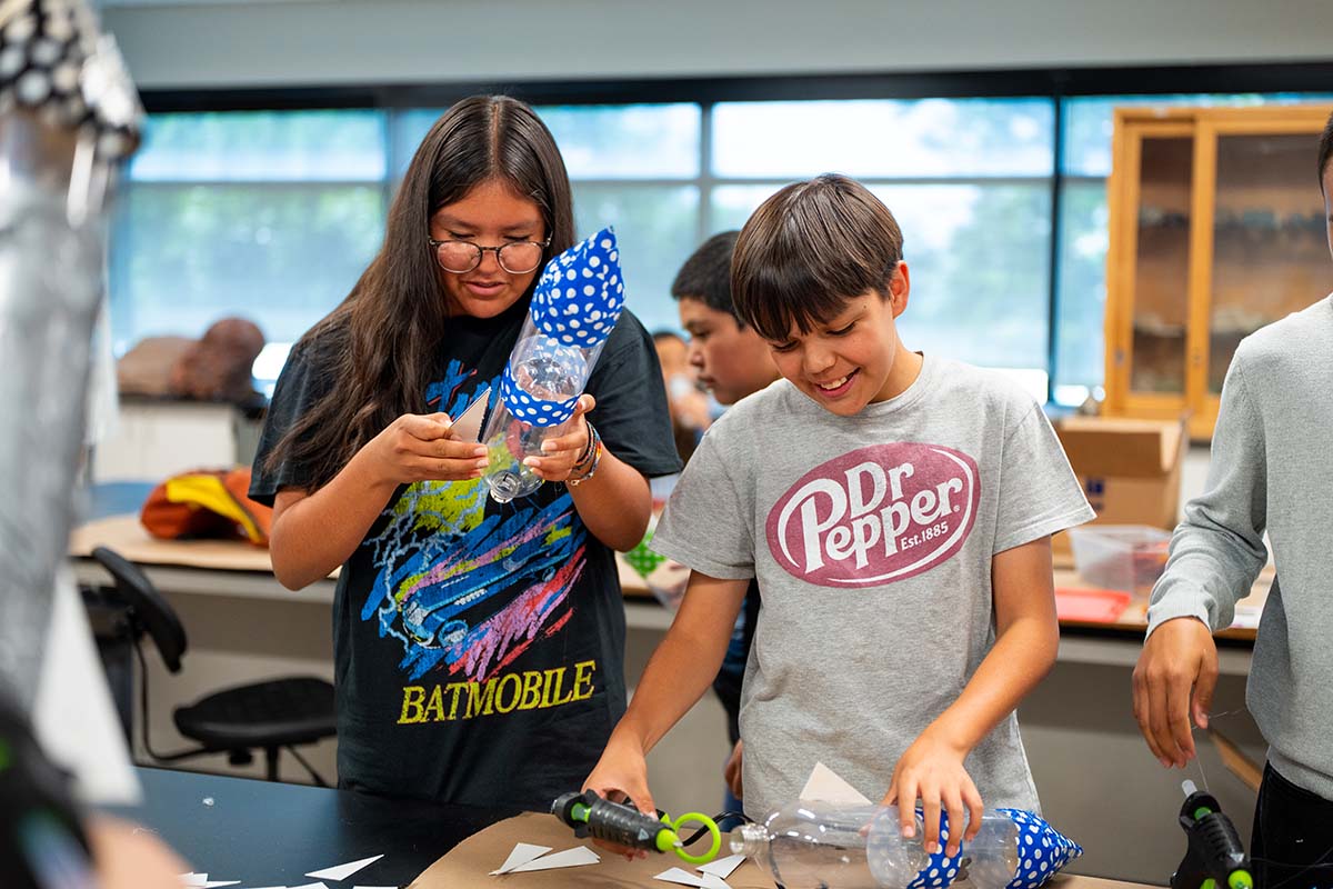 MSU Denver Summer Science Institute students Kendal Sandoval, left, and Oberklain Jauregui attach fins to their rockets.