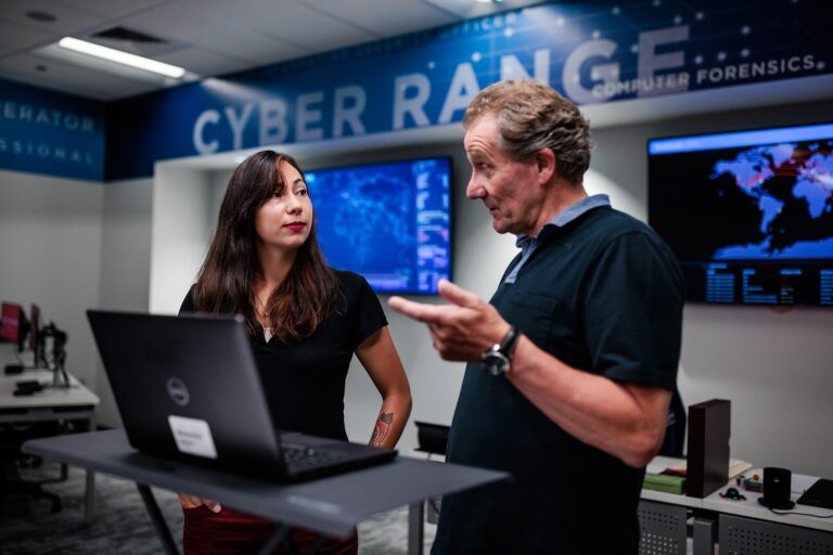 MSU Denver student Monica Ball and Cybersecurity Center Director Richard Mac Namee at work in MSU Denver’s Cyber Range.