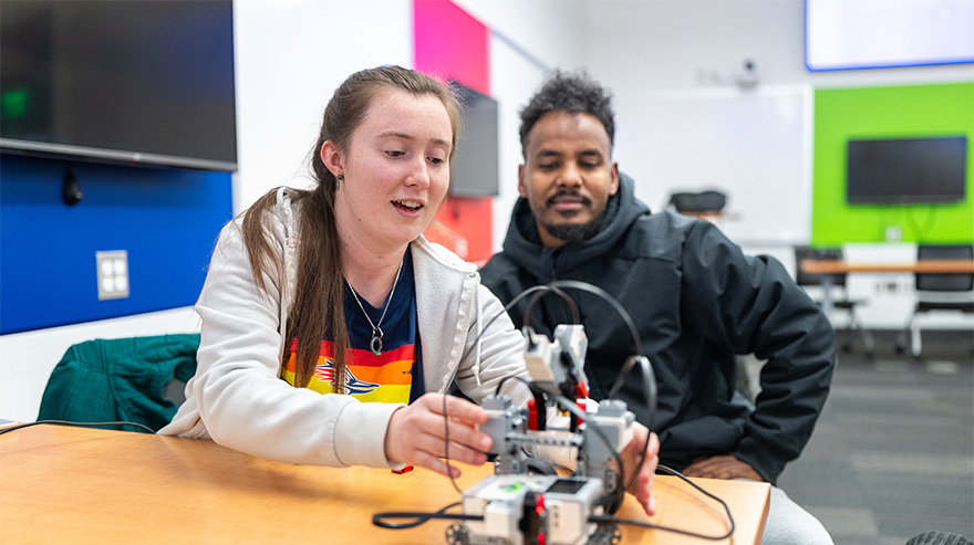 Students engage in a hands-on STEM learning activity in a classroom setting.