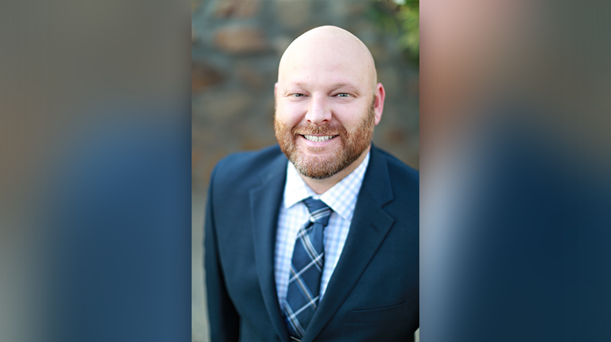 Portrait of MSU Denver’s inaugural executive director of housing and residence life, David McNabb, smiling in a suit and tie.