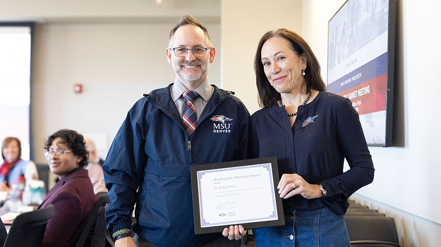 Dr. Brian O'Hara and Dr. Davidson holding the Roadrunner Shoutout Award