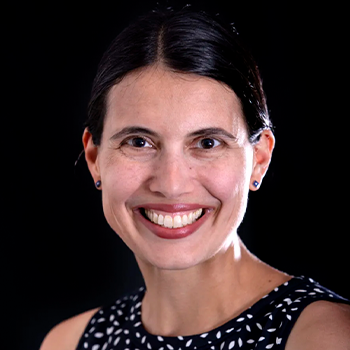 Headshot of Emily Ragan, Ph. D., with a black backdrop.