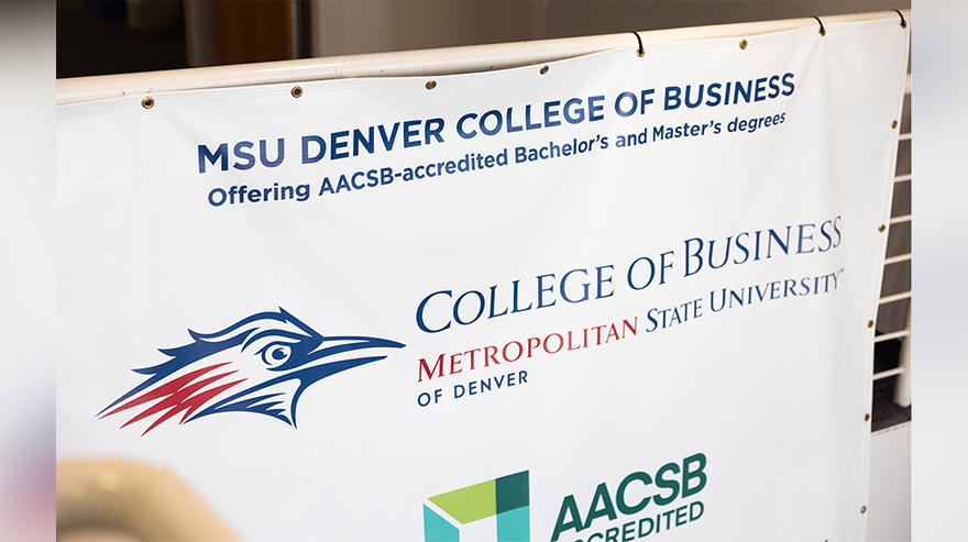 A sign displays the Metropolitan State University of Denver logo and College of Business heading above the logo for the Association to Advance Collegiate Schools of Business