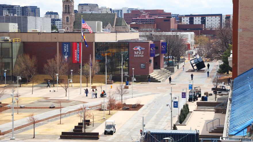 View of the MSU Denver campus plaza and surrounding academic buildings with people walking along the pathways.