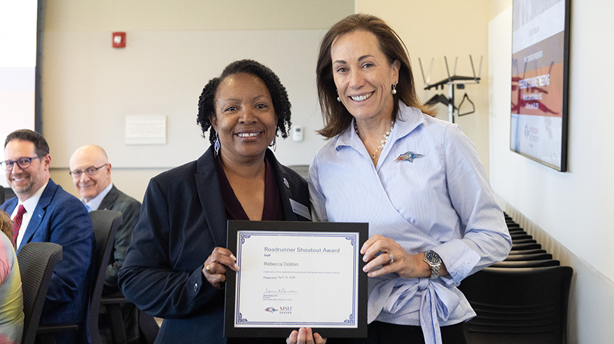 Rebecca Dobbin stands with Dr. Janine Davidson holding a Roadrunner Shoutout Award certificate.