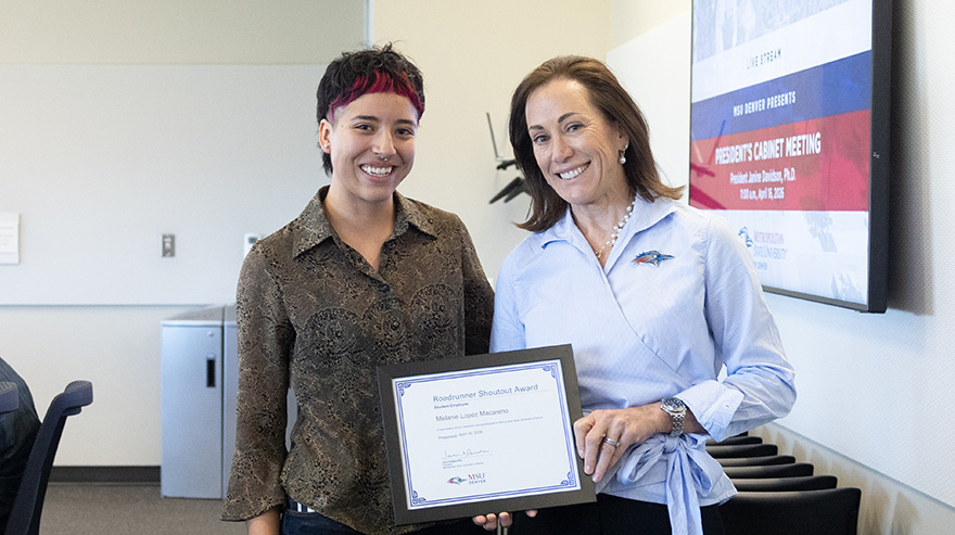 Melanie Lopez Macarena stands with Dr. Janine Davidson holding a Roadrunner Shoutout Award certificate.