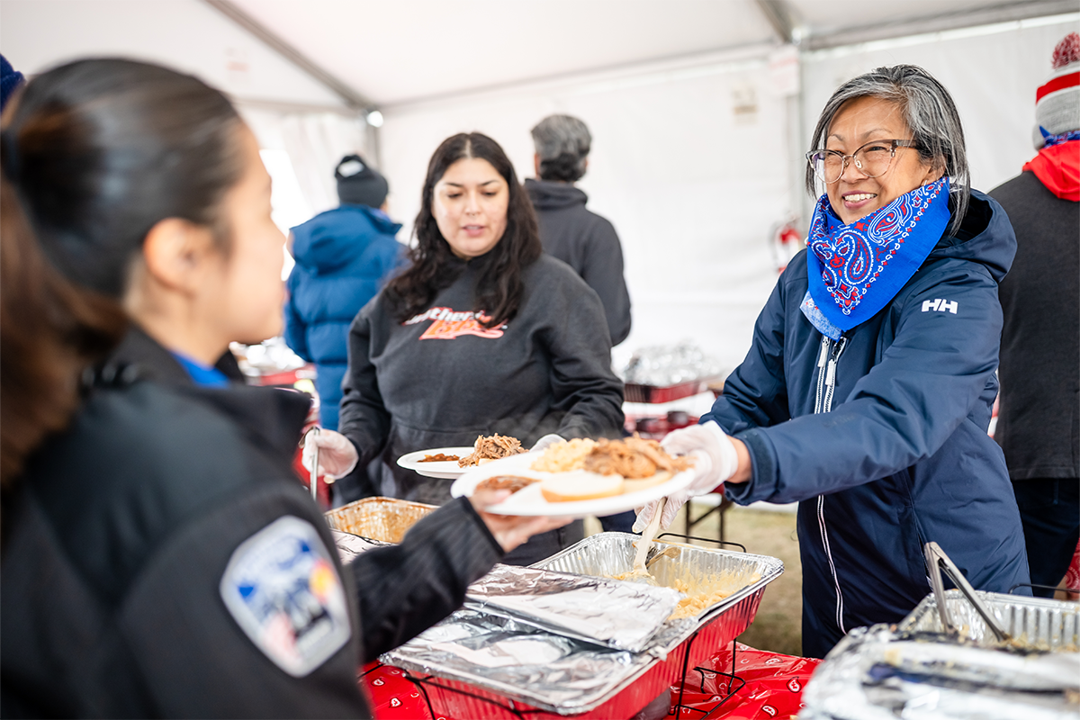 MSU Denver faculty and staff serving food to attendees during the Spring 2026 Howdy Rowdy BBQ event at the JSSB Lawn.