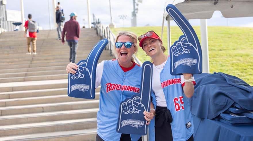 Members of the University Events Team hands out swag at the tailgate.