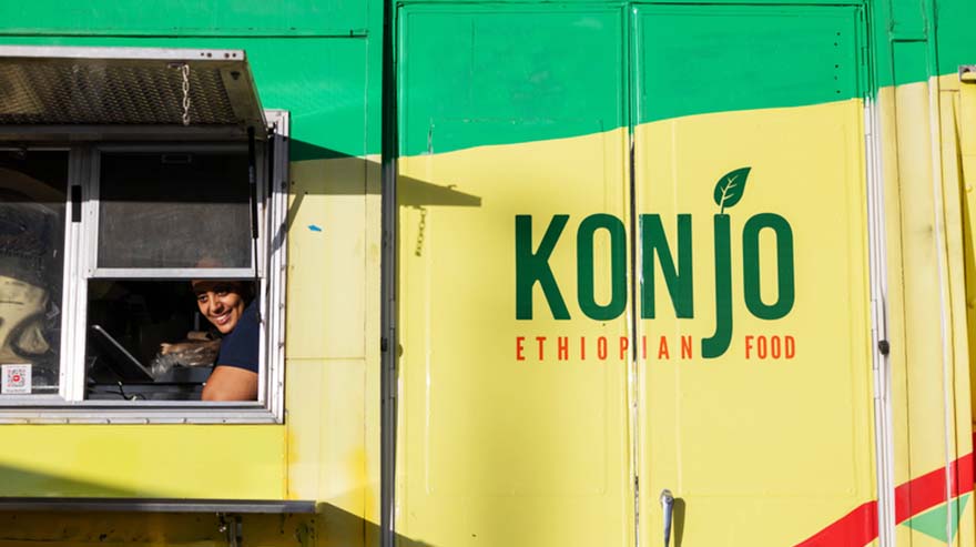 Alumna and chef/owner Fetien Gebre-Michael of Konjo Ethiopian food serves food at the Homecoming tailgate.