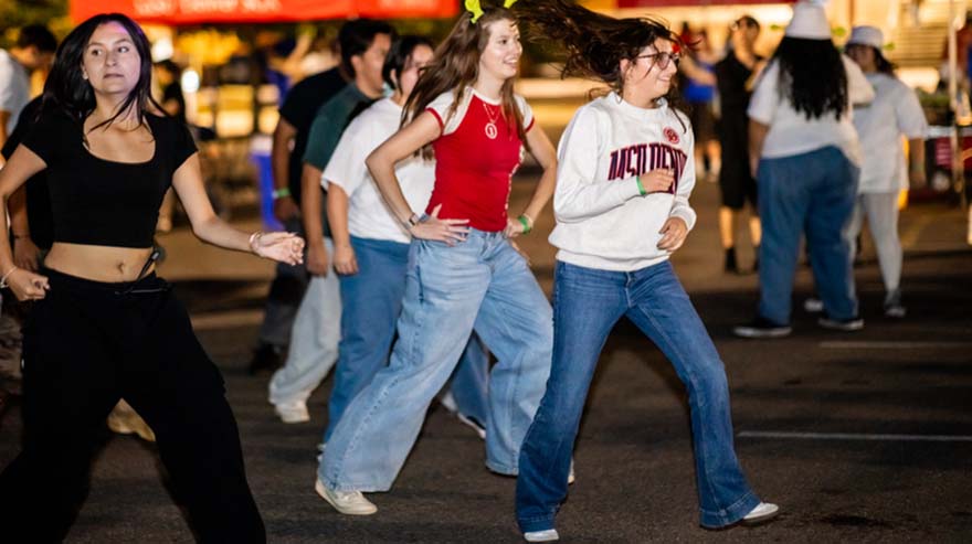 Students dance during the Homecoming movie night.
