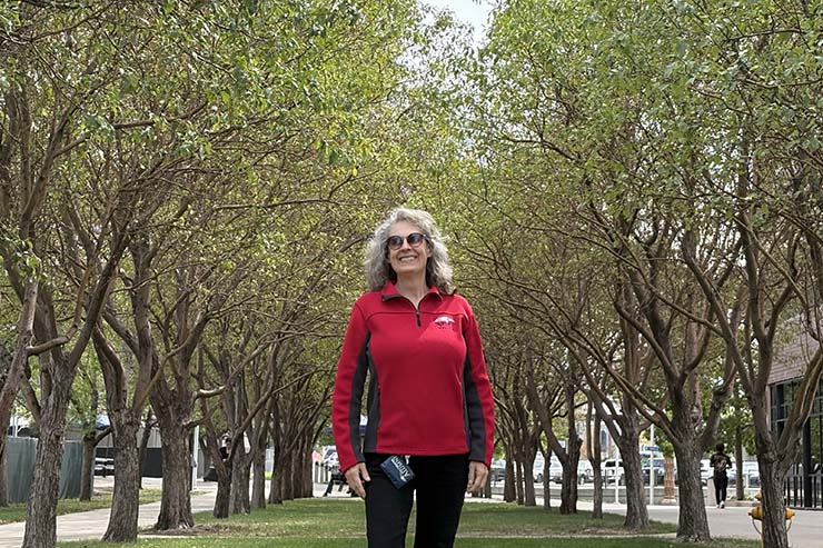 Beth Christensen in front of trees on Auraria Campus