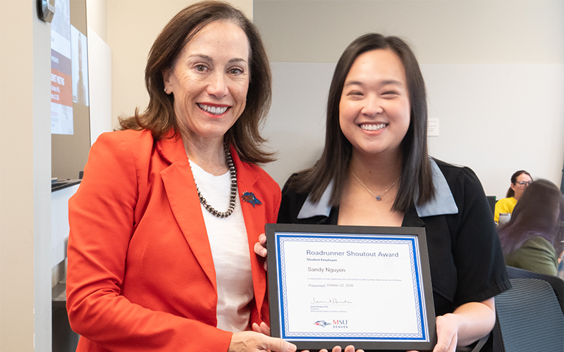 President Janine Davidson poses for a photo with Sandy Nguyen as both hold a Roadrunner Shoutout Award plaque addressed to Nguyen