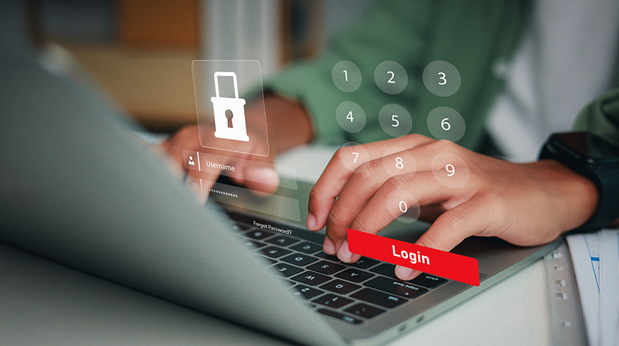 Stock image shows a person's hands on a laptop with an overlay display of a digital login interface